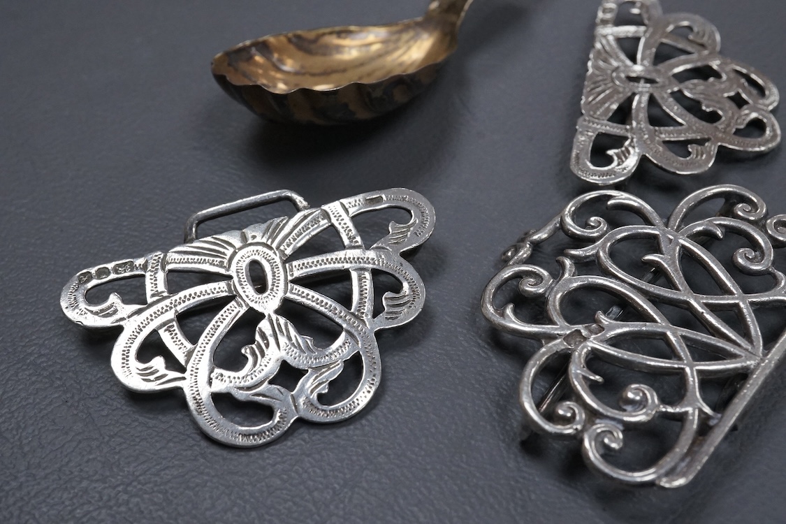 A group of small collectable silver including a white metal dragon menu holder? by Wang Hing, 92mm, two 19th century caddy spoons, three assorted belt buckles and a 1920's silver and enamel pill box(a.f), import marks fo